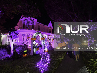 In the backyards of houses in the Celebration, FL, region, people create scary scenes with inflatable and luminous dolls for Halloween on Su...