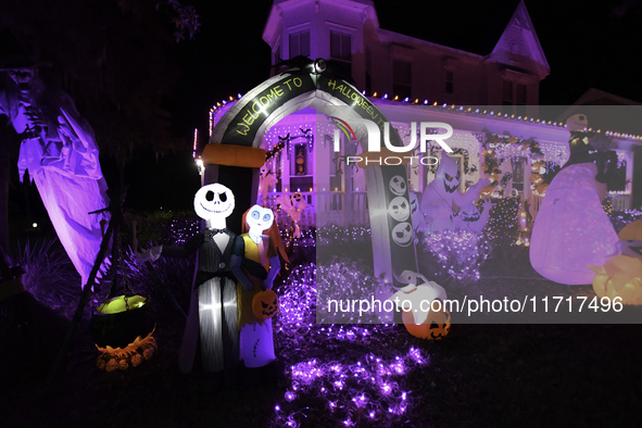 In the backyards of houses in the Celebration, FL, region, people create scary scenes with inflatable and luminous dolls for Halloween on Su...