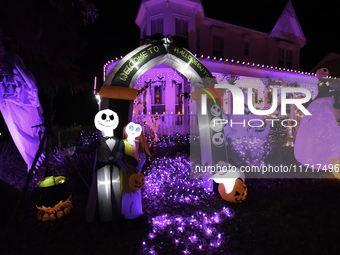 In the backyards of houses in the Celebration, FL, region, people create scary scenes with inflatable and luminous dolls for Halloween on Su...