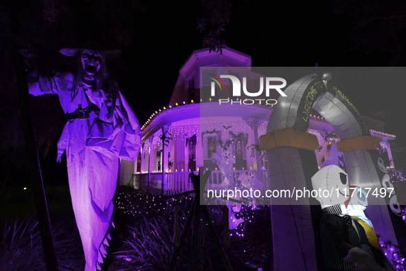 In the backyards of houses in the Celebration, FL, region, people create scary scenes with inflatable and luminous dolls for Halloween on Su...