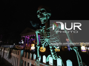 In the backyards of houses in the Celebration, FL, region, people create scary scenes with inflatable and luminous dolls for Halloween on Su...