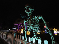 In the backyards of houses in the Celebration, FL, region, people create scary scenes with inflatable and luminous dolls for Halloween on Su...