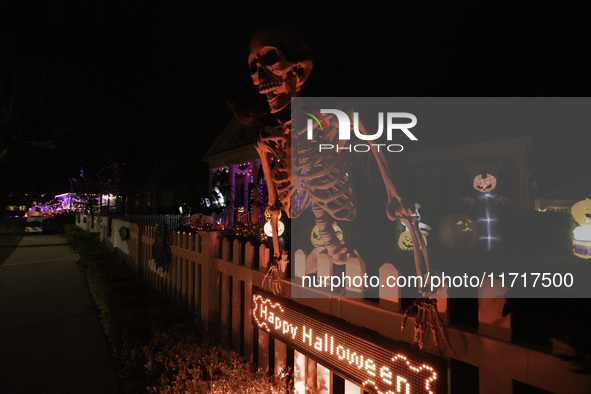 In the backyards of houses in the Celebration, FL, region, people create scary scenes with inflatable and luminous dolls for Halloween on Su...