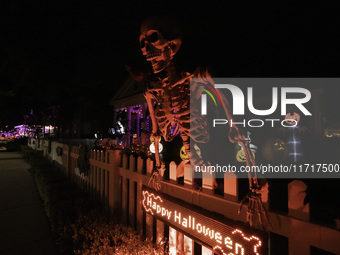 In the backyards of houses in the Celebration, FL, region, people create scary scenes with inflatable and luminous dolls for Halloween on Su...