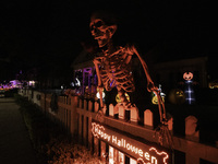 In the backyards of houses in the Celebration, FL, region, people create scary scenes with inflatable and luminous dolls for Halloween on Su...