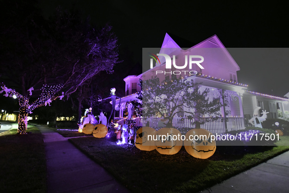 In the backyards of houses in the Celebration, FL, region, people create scary scenes with inflatable and luminous dolls for Halloween on Su...