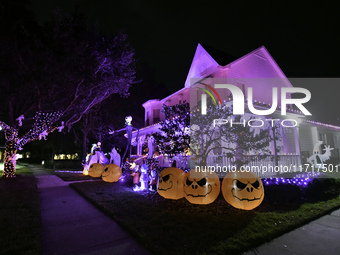 In the backyards of houses in the Celebration, FL, region, people create scary scenes with inflatable and luminous dolls for Halloween on Su...