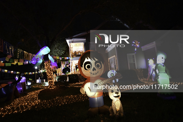 In the backyards of houses in the Celebration, FL, region, people create scary scenes with inflatable and luminous dolls for Halloween on Su...