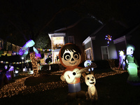 In the backyards of houses in the Celebration, FL, region, people create scary scenes with inflatable and luminous dolls for Halloween on Su...