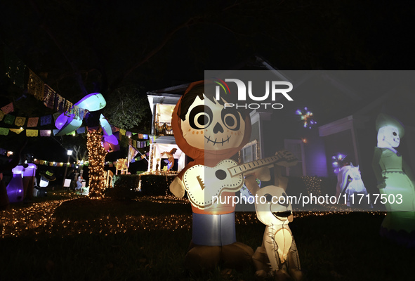 In the backyards of houses in the Celebration, FL, region, people create scary scenes with inflatable and luminous dolls for Halloween on Su...