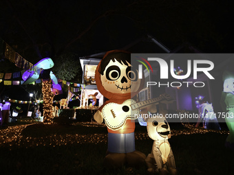 In the backyards of houses in the Celebration, FL, region, people create scary scenes with inflatable and luminous dolls for Halloween on Su...