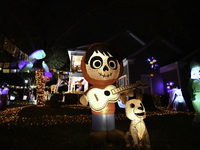 In the backyards of houses in the Celebration, FL, region, people create scary scenes with inflatable and luminous dolls for Halloween on Su...