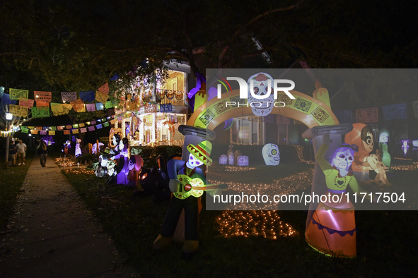 In the backyards of houses in the Celebration, FL, region, people create scary scenes with inflatable and luminous dolls for Halloween on Su...