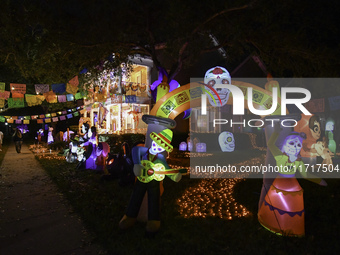 In the backyards of houses in the Celebration, FL, region, people create scary scenes with inflatable and luminous dolls for Halloween on Su...