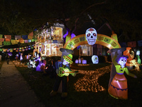 In the backyards of houses in the Celebration, FL, region, people create scary scenes with inflatable and luminous dolls for Halloween on Su...