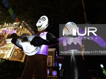 In the backyards of houses in the Celebration, FL, region, people create scary scenes with inflatable and luminous dolls for Halloween on Su...