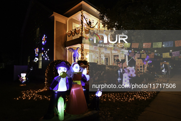 In the backyards of houses in the Celebration, FL, region, people create scary scenes with inflatable and luminous dolls for Halloween on Su...