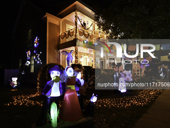 In the backyards of houses in the Celebration, FL, region, people create scary scenes with inflatable and luminous dolls for Halloween on Su...