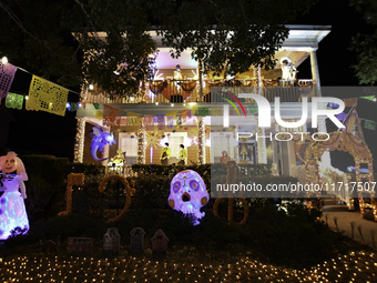 In the backyards of houses in the Celebration, FL, region, people create scary scenes with inflatable and luminous dolls for Halloween on Su...