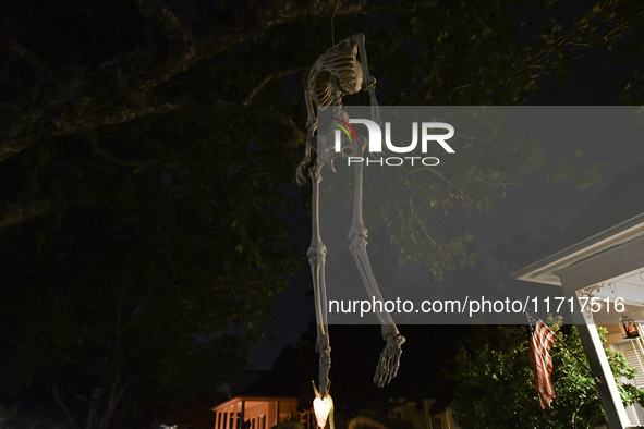 In the backyards of houses in the Celebration, FL, region, people create scary scenes with inflatable and luminous dolls for Halloween on Su...