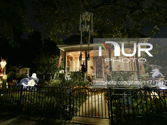 In the backyards of houses in the Celebration, FL, region, people create scary scenes with inflatable and luminous dolls for Halloween on Su...