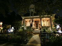 In the backyards of houses in the Celebration, FL, region, people create scary scenes with inflatable and luminous dolls for Halloween on Su...