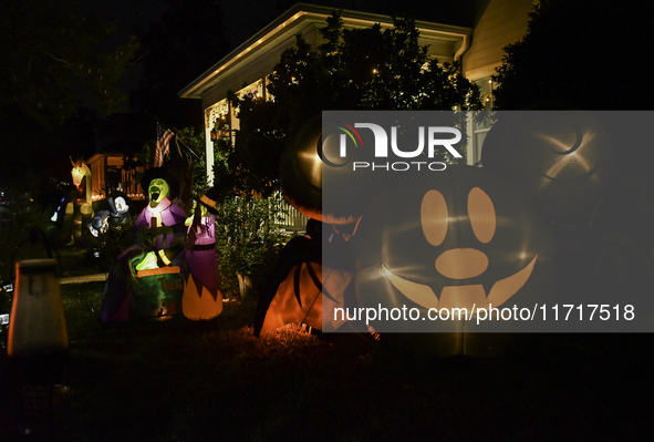 In the backyards of houses in the Celebration, FL, region, people create scary scenes with inflatable and luminous dolls for Halloween on Su...