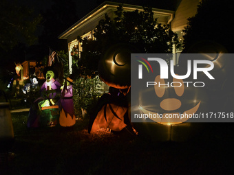 In the backyards of houses in the Celebration, FL, region, people create scary scenes with inflatable and luminous dolls for Halloween on Su...