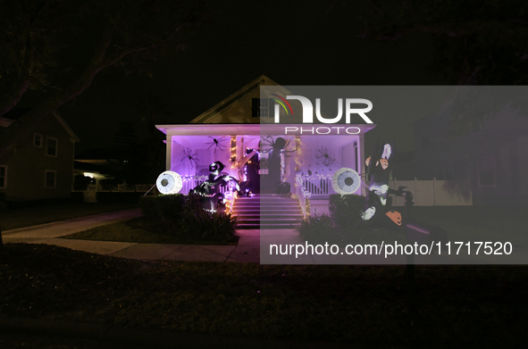 In the backyards of houses in the Celebration, FL, region, people create scary scenes with inflatable and luminous dolls for Halloween on Su...