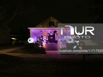 In the backyards of houses in the Celebration, FL, region, people create scary scenes with inflatable and luminous dolls for Halloween on Su...