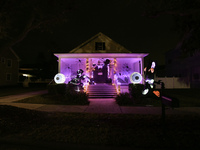 In the backyards of houses in the Celebration, FL, region, people create scary scenes with inflatable and luminous dolls for Halloween on Su...