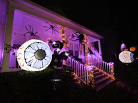 In the backyards of houses in the Celebration, FL, region, people create scary scenes with inflatable and luminous dolls for Halloween on Su...