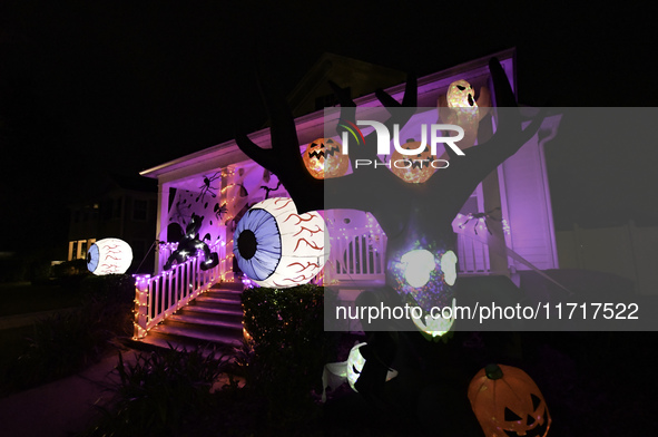 In the backyards of houses in the Celebration, FL, region, people create scary scenes with inflatable and luminous dolls for Halloween on Su...