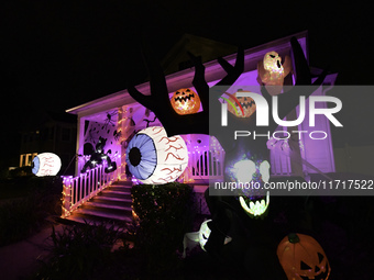 In the backyards of houses in the Celebration, FL, region, people create scary scenes with inflatable and luminous dolls for Halloween on Su...