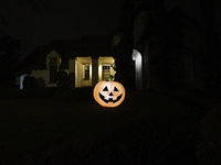 In the backyards of houses in the Celebration, FL, region, people create scary scenes with inflatable and luminous dolls for Halloween on Su...