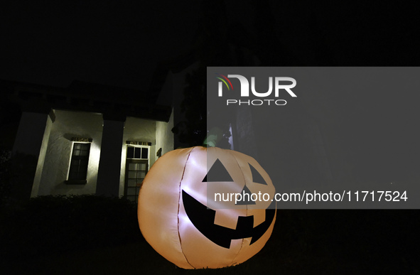 In the backyards of houses in the Celebration, FL, region, people create scary scenes with inflatable and luminous dolls for Halloween on Su...