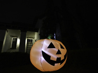 In the backyards of houses in the Celebration, FL, region, people create scary scenes with inflatable and luminous dolls for Halloween on Su...