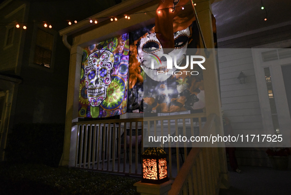 In the backyards of houses in the Celebration, FL, region, people create scary scenes with inflatable and luminous dolls for Halloween on Su...