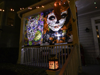 In the backyards of houses in the Celebration, FL, region, people create scary scenes with inflatable and luminous dolls for Halloween on Su...