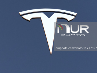 The iconic Tesla logo is displayed on the hood of a Model 3 electric car in Monopoli, Italy, on October 12, 2024. (