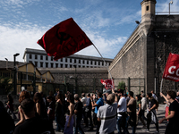 A demonstration takes place in Naples, Italy, outside the Poggioreale prison, where unemployed and working people gather to protest against...