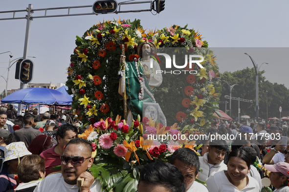 View of an image of Saint Jude Thaddeus outside the Church of San Hipolito in Mexico City, Mexico, on October 28, 2024. A large number of pe...