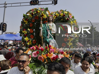 View of an image of Saint Jude Thaddeus outside the Church of San Hipolito in Mexico City, Mexico, on October 28, 2024. A large number of pe...