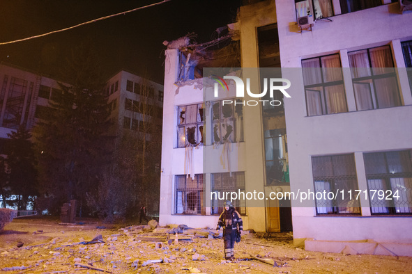 A firefighter stands near the affected building , on October 28, 2024, In The Center Of Kharkiv, Ukraine. 