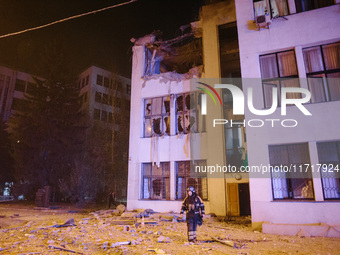 A firefighter stands near the affected building , on October 28, 2024, In The Center Of Kharkiv, Ukraine. (