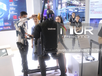 A Unitree robot dog and a model walk on the runway during Fashion Week in Shanghai, China, on October 27, 2024. (