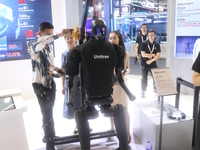 A Unitree robot dog and a model walk on the runway during Fashion Week in Shanghai, China, on October 27, 2024. (