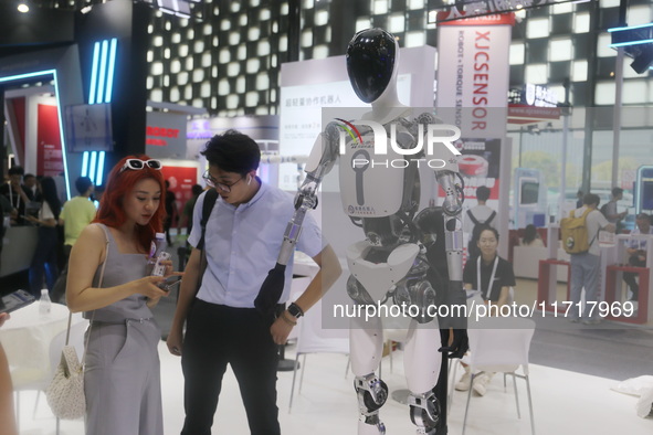 A Unitree robot dog and a model walk on the runway during Fashion Week in Shanghai, China, on October 27, 2024. 