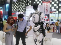 A Unitree robot dog and a model walk on the runway during Fashion Week in Shanghai, China, on October 27, 2024. (