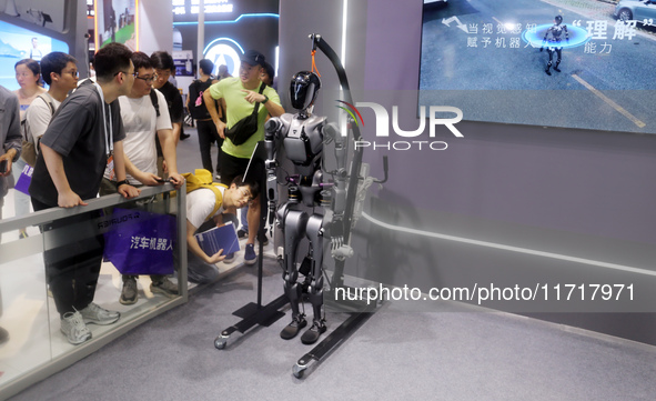 A Unitree robot dog and a model walk on the runway during Fashion Week in Shanghai, China, on October 27, 2024. 